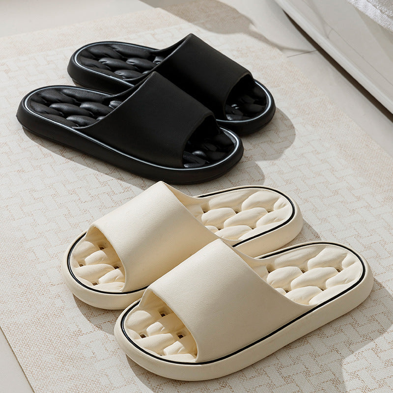 Black and off-white open-toe slide slippers with thick sole and molded footbed.