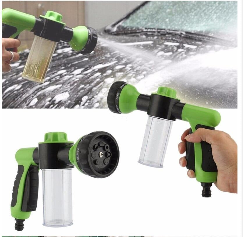 Green and black foam spray gun dispensing foam with clear container bottle