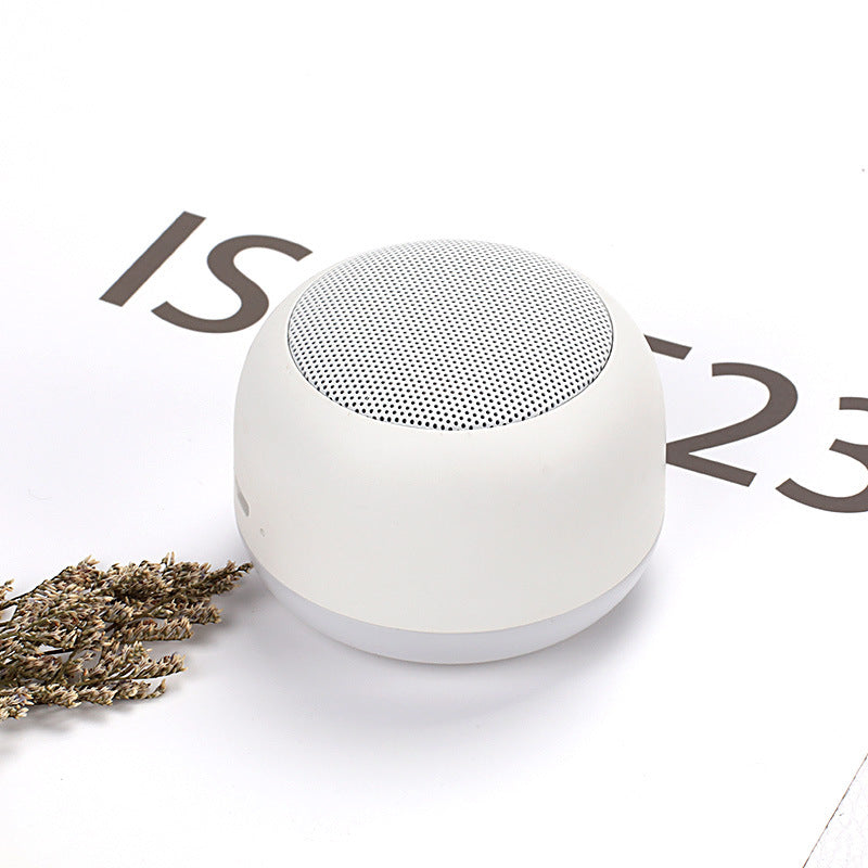 Wireless Bluetooth mini speaker, white with textured grille top and rounded body