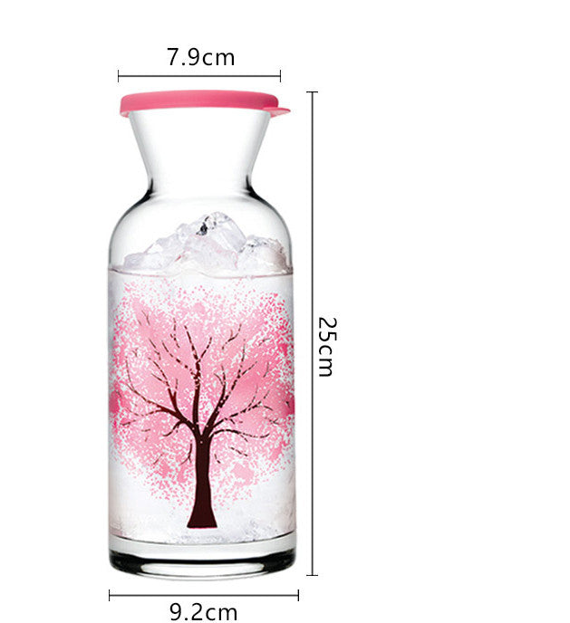 Tall glass water bottle with pink tree design and red rim, 25cm height