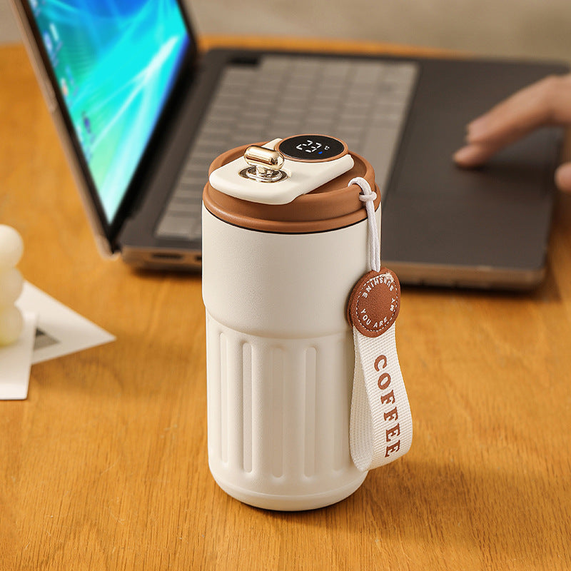 White vacuum insulated coffee mug thermos with digital display, brown-rim lid, and strap