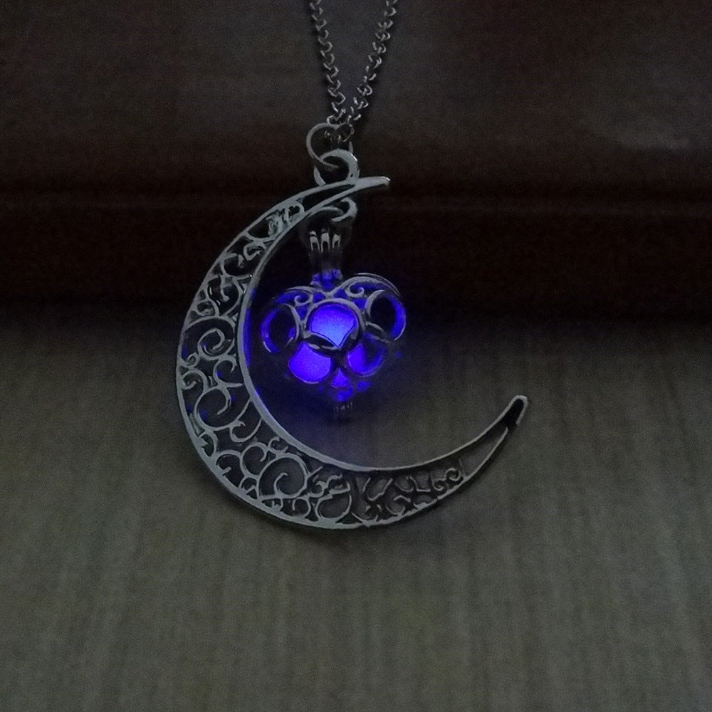 Crescent moon pendant necklace with purple glowing cat paw on a silver chain