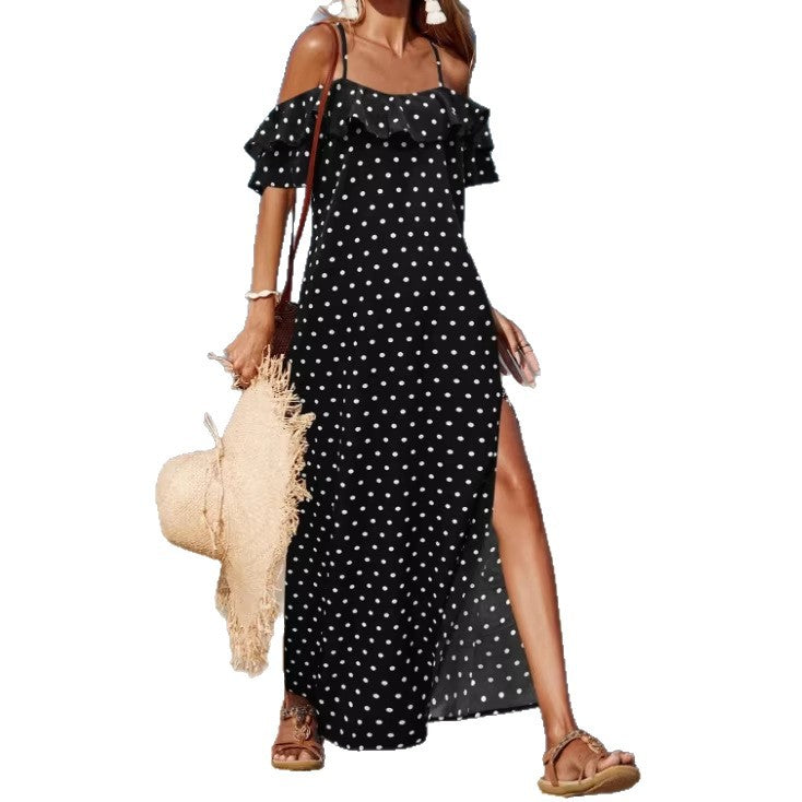 Off-shoulder long polka dot dress in black with white dots, ruffled sleeves and side slit