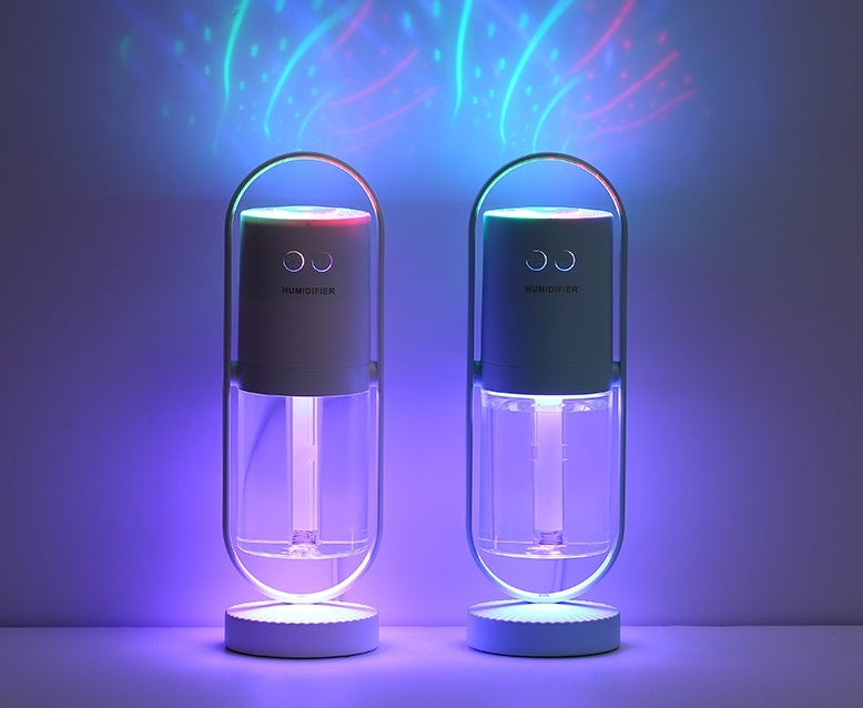 Pair of dark USB air humidifiers with multicolor glowing tops and clear mist tubes