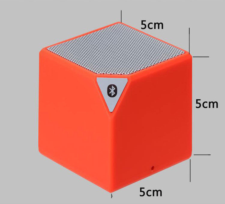 Orange Rubik's Cube Bluetooth speaker cube design with top mesh and Bluetooth icon