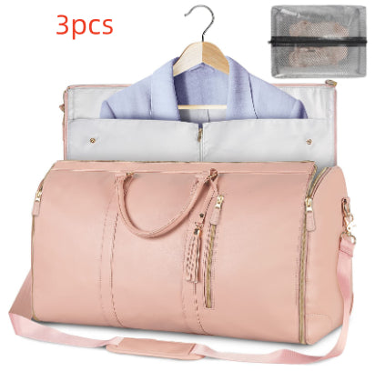 Pink foldable travel duffle bag with front zipper, side tassel pulls, shoulder strap