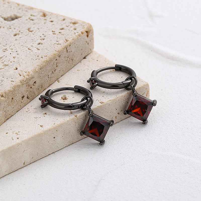Black gold hoop earrings with square red crystal dangles