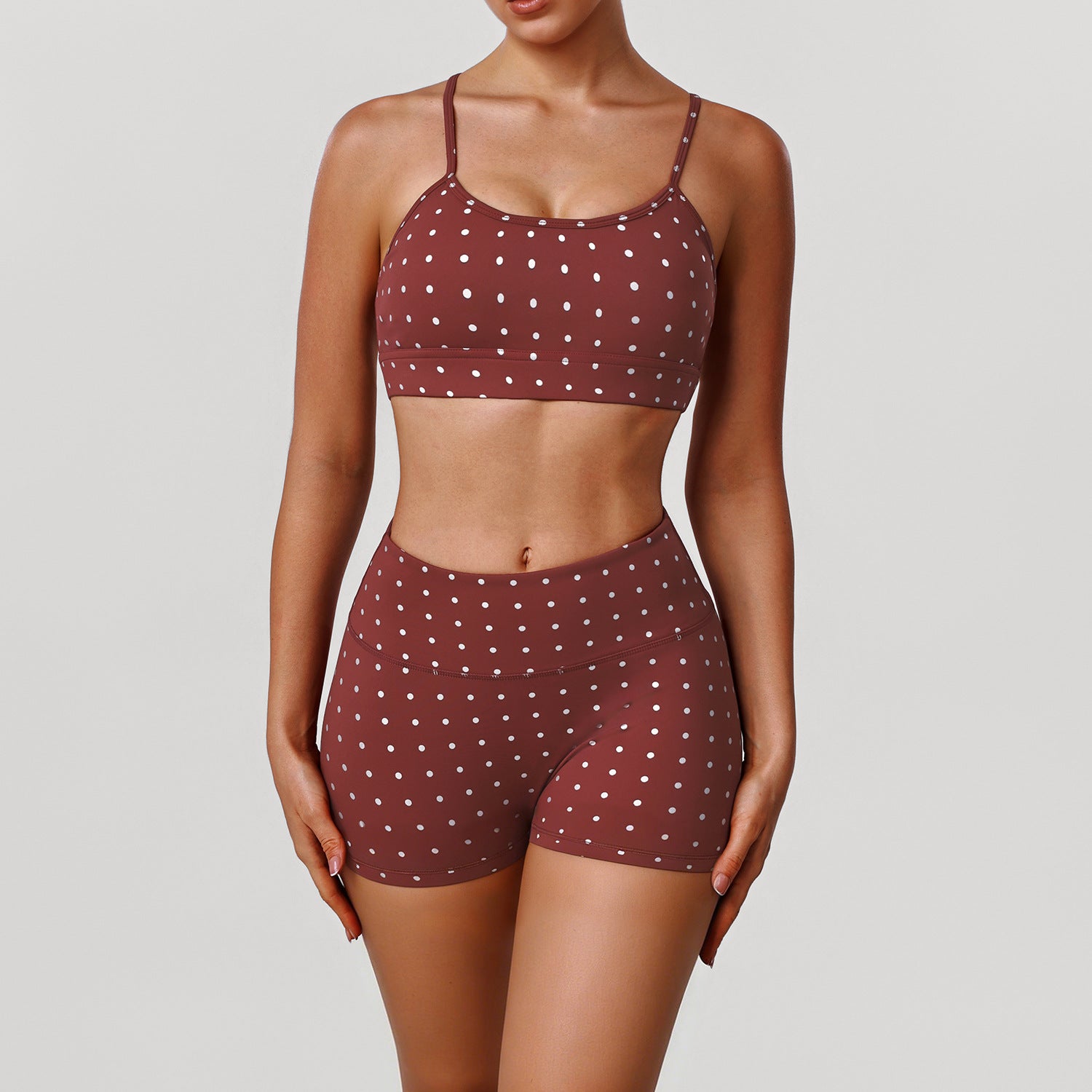 Women’s rust red sports bra and shorts set with white dot print, thin straps