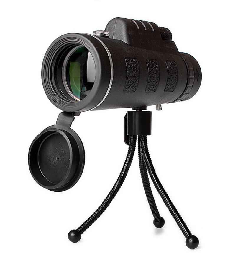Monocular telescope zoom scope with green-tinted eyepiece and tripod legs