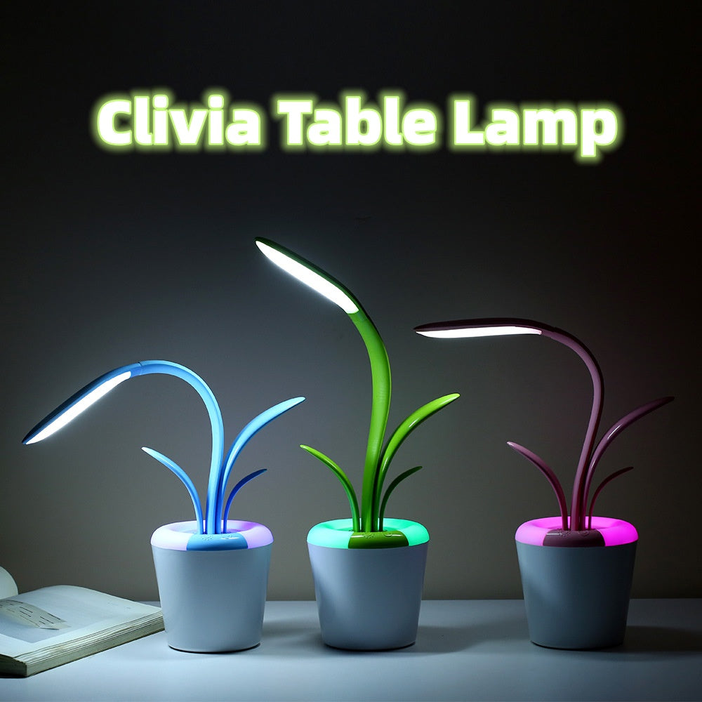 LED table lamp with glowing neon plant stems (blue/green/purple) and white pot