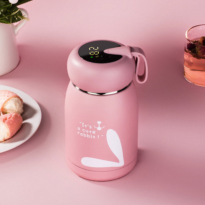 Pink insulated thermos bottle with digital temperature display and bunny graphic
