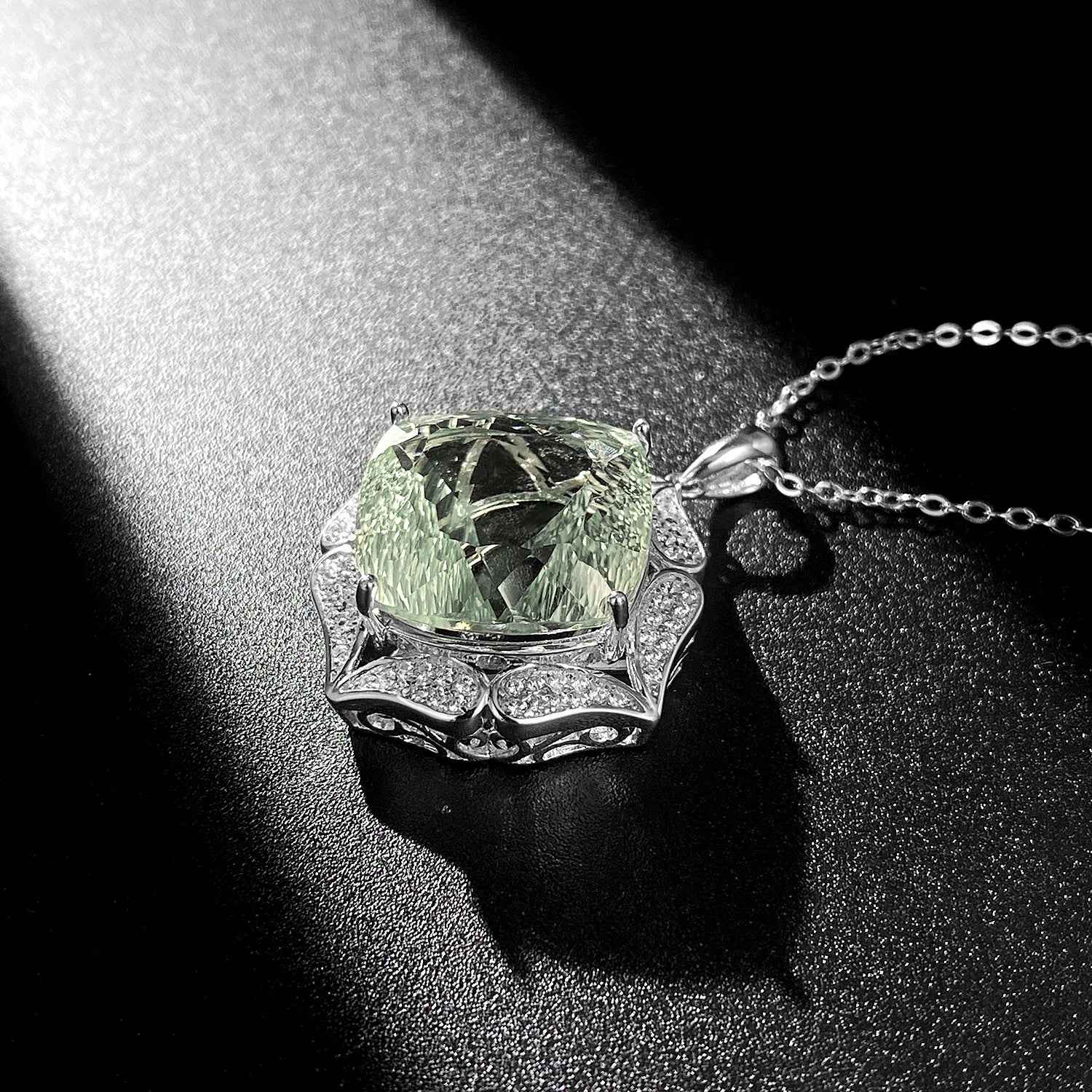Green crystal pendant necklace with silver-toned prong setting and chain links