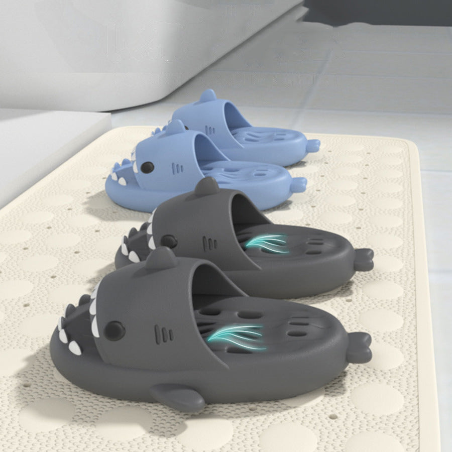 Dark gray shark-shaped EVA shower slide with drainage holes and textured sole