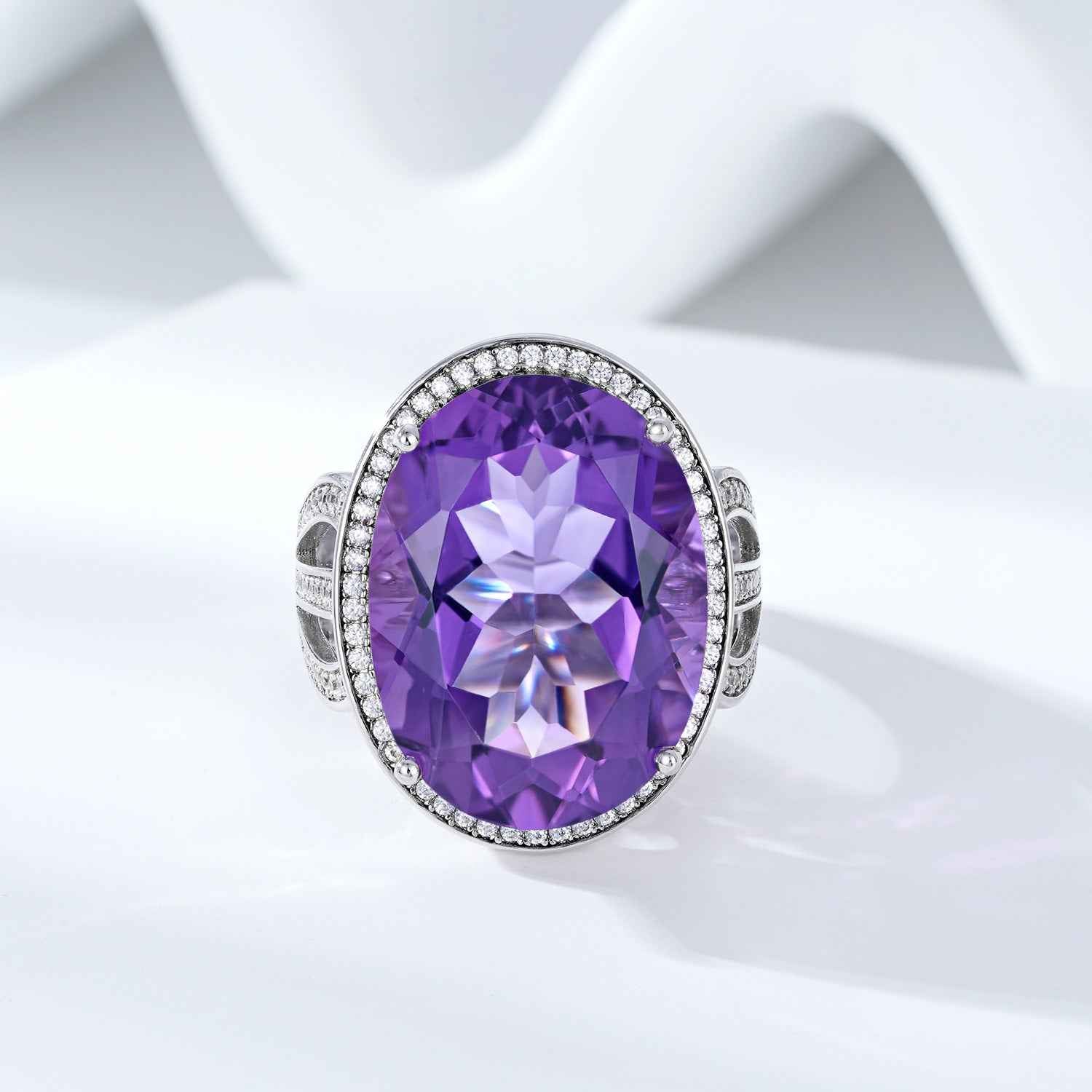 Silver amethyst ring with oval purple gemstone and sparkling halo bezel