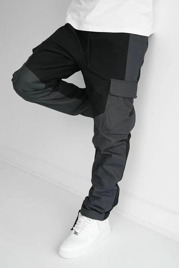 Black cargo trousers with thigh pocket flap, relaxed fit, cuffed ankles