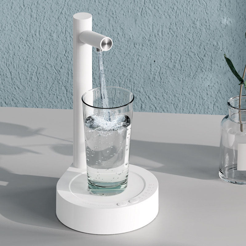 White electric water dispenser with spout pouring into glass cup, round base
