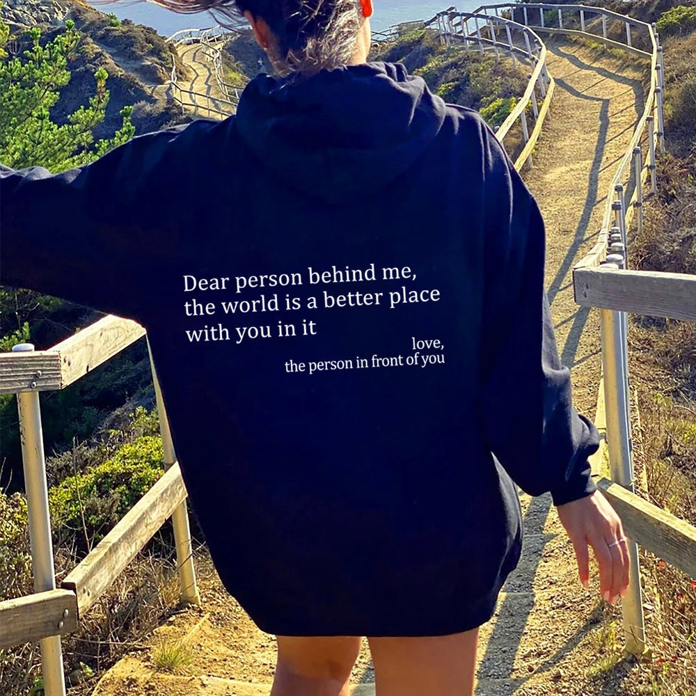 Dark plush hoodie with kangaroo pocket, drawstring hood, and back letter print