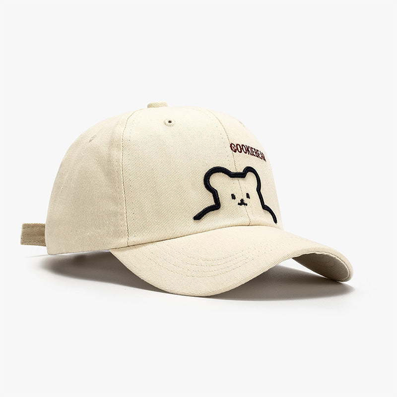 Beige baseball cap with bear outline patch and curved brim