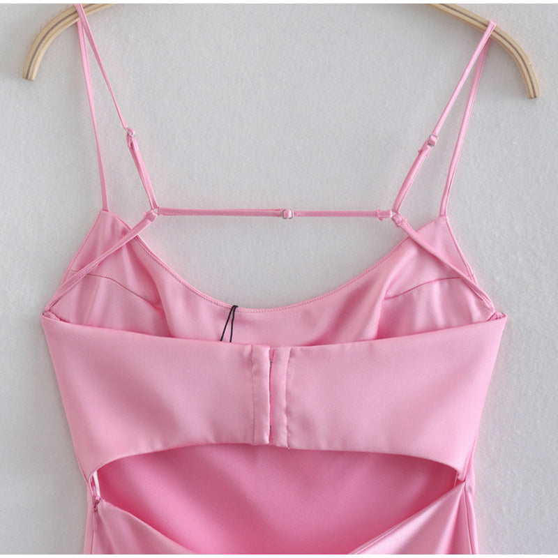 Pink satin backless slip dress showing strappy back and hook closure