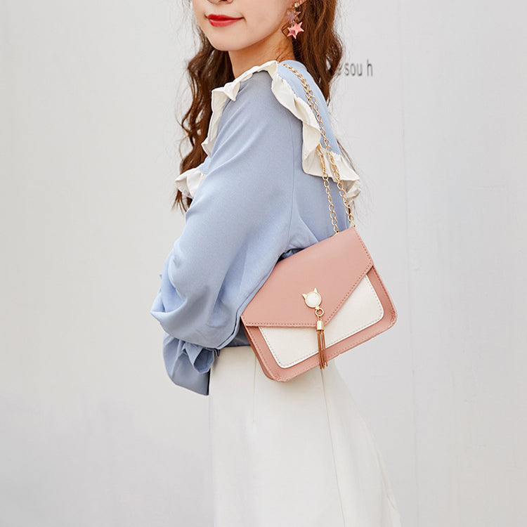 Small messenger bag, pink with white panel, cat charm clasp, gold chain strap