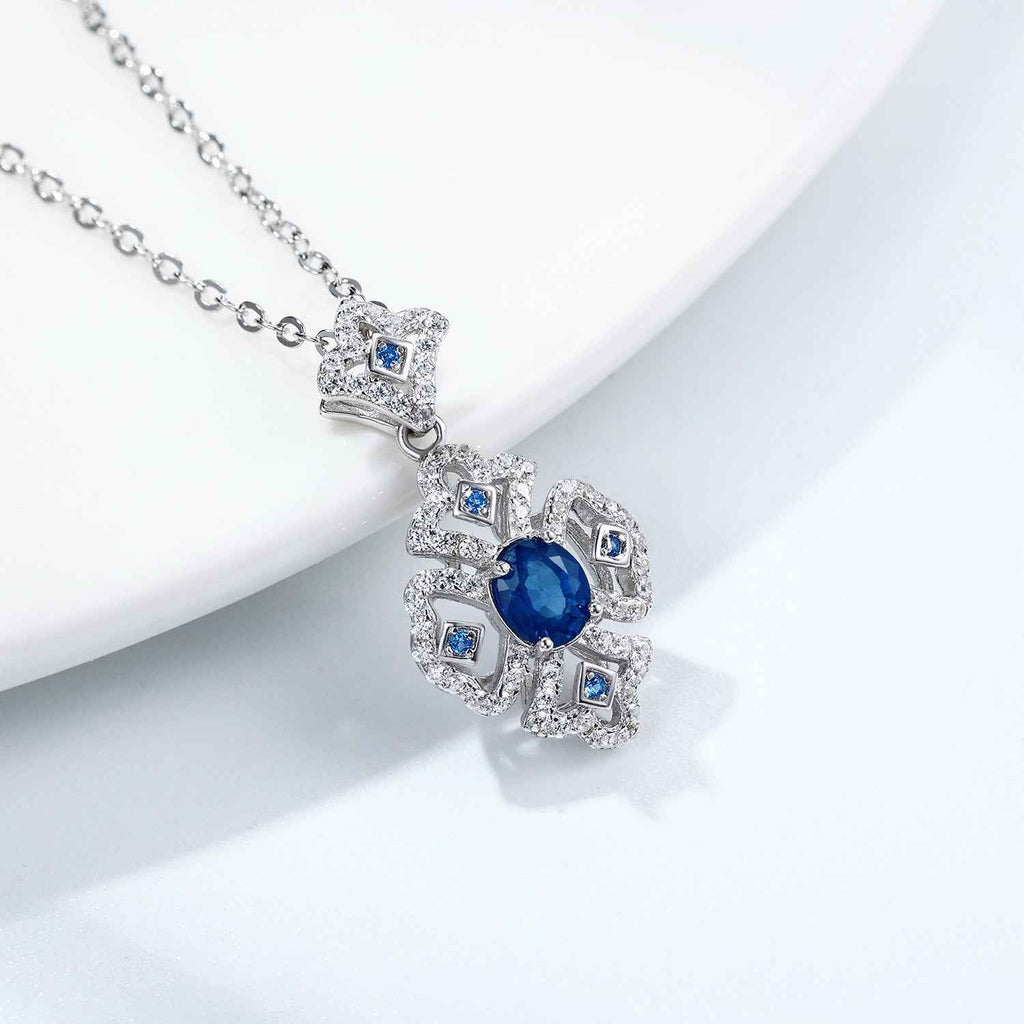 Silver necklace with blue sapphire cluster pendant and square halo stones